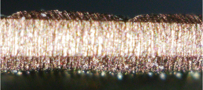 Cross section of a gold-copper-silver alloy plate after depletion gilding